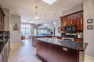 a large kitchen with a large island in the middle at 3BR home with private pool 3 mins 2 Riverplace in Austin