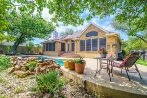 a house with a pool and a table and chairs at 3BR home with private pool 3 mins 2 Riverplace in Austin