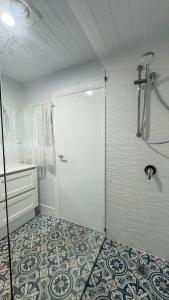 a bathroom with a shower and a white door at Oscar's Place in Yass