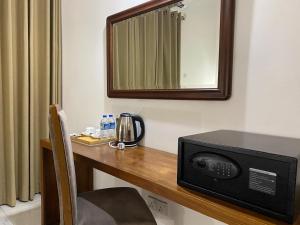a microwave sitting on a desk in a room at River Tree Bolgoda in Panadura