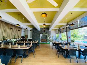 a dining room with tables and chairs and a pool at River Tree Bolgoda in Panadura