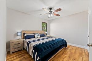a bedroom with a bed and a ceiling fan at Pines and Patio Hideaway in Conroe