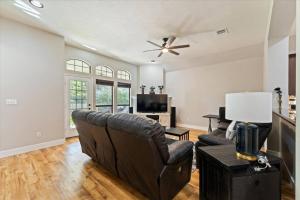 a living room with a couch and a tv at Pines and Patio Hideaway in Conroe