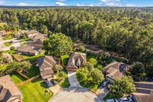 an aerial view of a home with trees at Pines and Patio Hideaway in Conroe