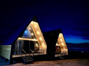 a house with lights on it at night at Tengri House A-Frame Issyk-Kul in Kaji-Say