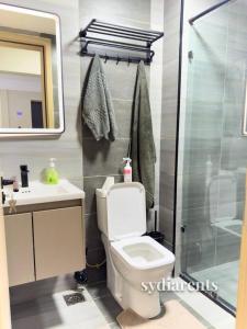 a bathroom with a shower and a toilet and a sink at Leo Residency in Nairobi