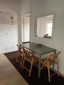 a dining room with a green table and two chairs at Valentinas retreat in San Dorligo della Valle