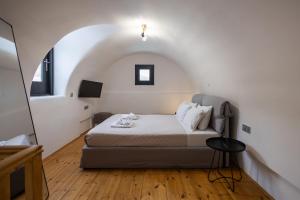 a bedroom with a bed in a small room at Aerial Villas in Imerovigli