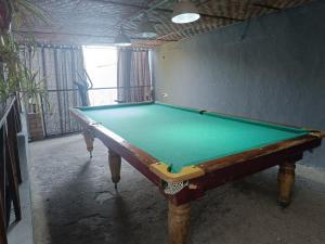 a pool table in a room with a green cloth at Дача Уют Чарвак Узбекистан in Chorwoq