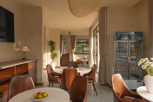 a dining room with a table and chairs at Velora Hotel DaLat in Xuan An
