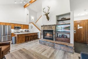 a kitchen and living room with a fireplace at Los Pinos 22C by Great Western Lodging in Breckenridge