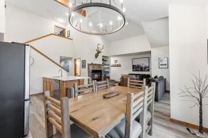 a dining room and living room with a table and a refrigerator at Los Pinos 22C by Great Western Lodging in Breckenridge +83 photos