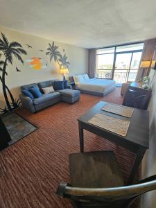 a living room with a couch and a table at Oceanview Room at Landmark Resort in Myrtle Beach