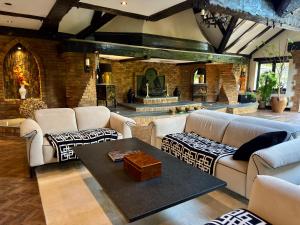 a living room with couches and a brick wall at Balancyoga Guesthouse in Ash