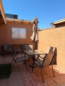 a table and chairs with an umbrella on a patio at RUDRASAI 2611-Tempe,AZ in Tempe