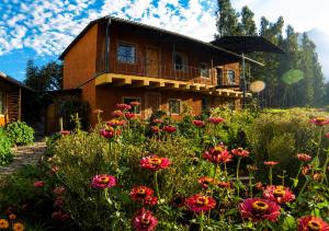 a house with flowers in front of it at IntiRumi Inn in Caraz