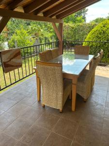 a wooden table and chairs on a patio at Stella apartman in Gabčíkovo