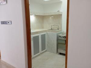 a small kitchen with a sink and a stove at East HOME Kalmunai in Kalmunai