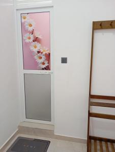 a room with a door with a painting of flowers at East HOME Kalmunai in Kalmunai +1 photo