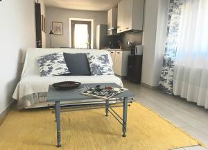 a room with a bed and a table in front of it at A Casa di Laura in Parella