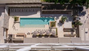 a building with a swimming pool on the side of it at Turia Badajoz in Badajoz