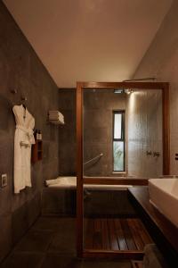 a bathroom with a shower and a tub and a sink at Nardazul "Casa de Sueños" in Oaxaca City +90 photos