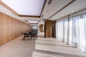 a conference room with tables and chairs and windows at Turia Badajoz in Badajoz +92 photos