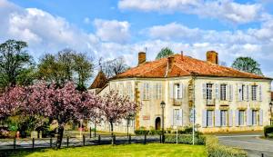an old building with trees in front of it at Château Arche d'Aure in Vicq-dʼAuribat