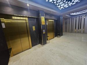 a row of elevators in a building with doors at NATALIA - Building Stefan Resort II in Năvodari
