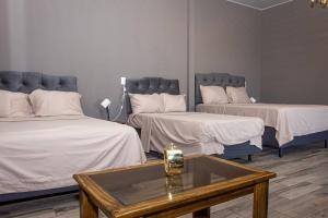 a room with two beds and a coffee table at Cozy Cabin in Cumbres del Nacimiento, La Unión Sur in Conchagua +13 photos
