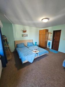 a bedroom with a blue bed with a tray on it at Regina's Guesthouse in Balchik +51 photos