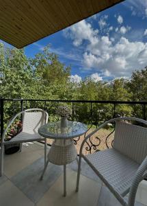 a patio with a table and chairs on a balcony at LeriMari in Mestia