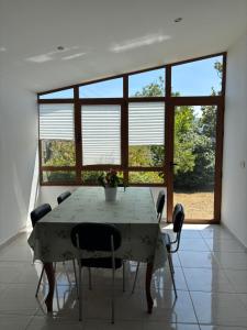 a dining room with a table and chairs and a window at Chalet do Médico in Rodeiro +16 photos