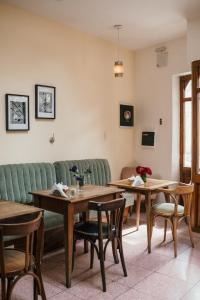 a living room with tables and a green couch at La Noire Petit hotel in Buenos Aires
