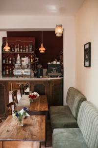 a restaurant with a couch and tables and a bar at La Noire Petit hotel in Buenos Aires