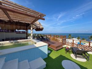 a resort with a swimming pool and the ocean at Suites Valentina in Puerto Morelos
