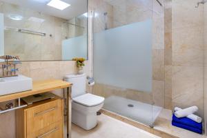 a bathroom with a shower and a toilet and a sink at Casa Ocean Love Sea View Duplex Tauro Golf in Mogán +18 photos