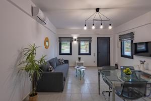 a living room with a couch and a glass table at Aerial Villas in Imerovigli