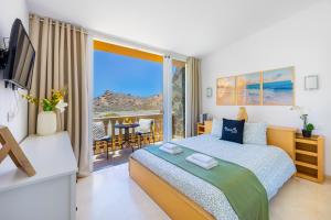a bedroom with a bed and a balcony with a view at Casa Ocean Love Sea View Duplex Tauro Golf in Mogán