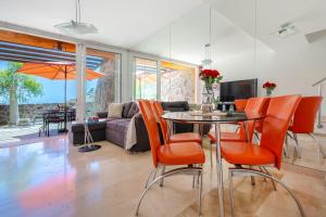 a living room with a table and orange chairs at Casa Ocean Love Sea View Duplex Tauro Golf in Mogán