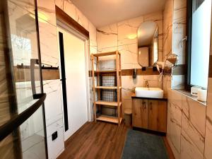 a small bathroom with a sink and a mirror at Niebieska Stodoła Karkonoska in Podgórzyn +1 photo