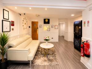 a living room with a couch and a table at Wool Merchant Hotel HALIFAX in Halifax