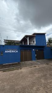 a blue building with the word america on it at Pousada & Hostel América in Barreirinhas +6 photos