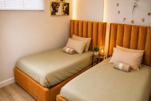 two beds in a small room withermottermott at MariSal at 77 Independence avenue CBD in Windhoek