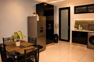 a kitchen and dining room with a table and a refrigerator at MariSal at 77 Independence avenue CBD in Windhoek