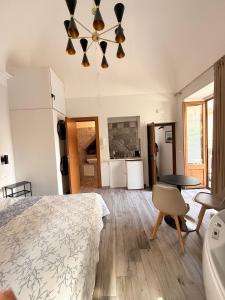 a bedroom with a bed and a dining room at Vacanze d'amore in Cefalù