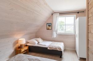 a room with two beds and a window at Domki Nad Morzem Babki z Piasku Dziwnów in Dziwnów