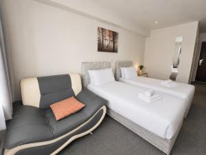 a hotel room with a bed and a couch at Wool Merchant Hotel HALIFAX in Halifax