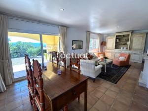 a living room with a wooden table and chairs at Casa Torrebosca 43 in Platja d'Aro