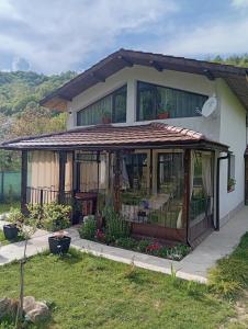 a house with a gazebo at къща за гости Горски чар in Beli Osŭm